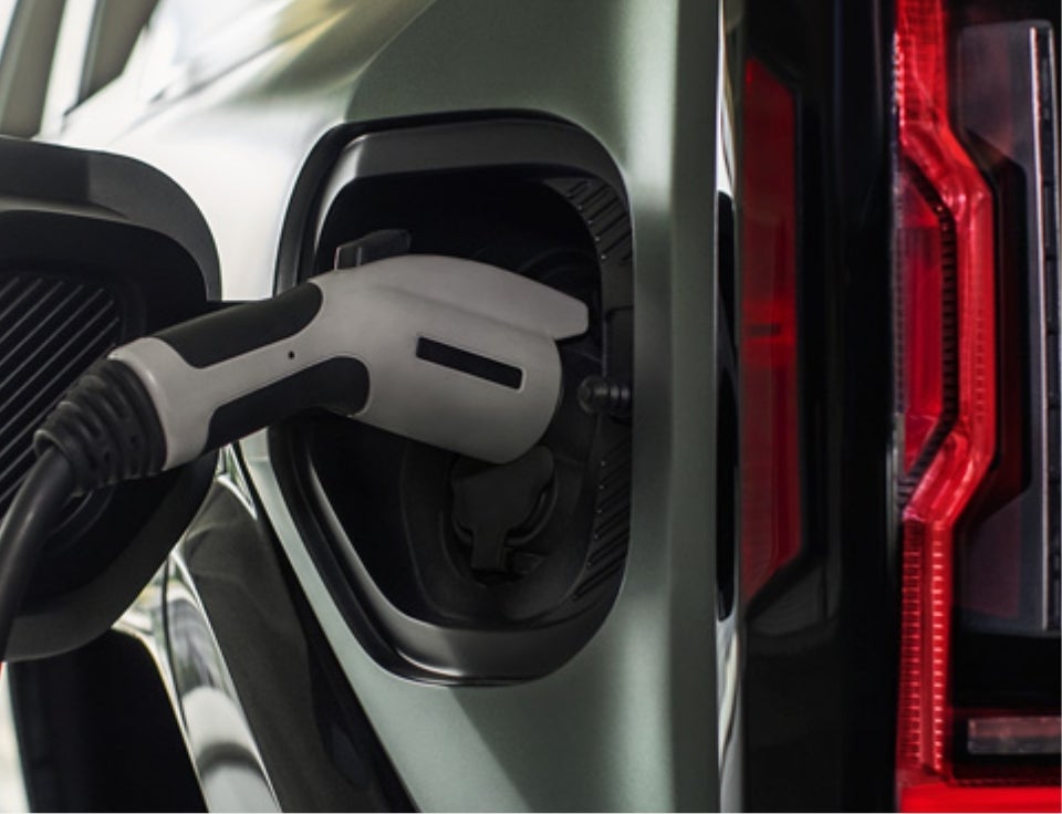 Close up of charging port with charger plugged in on a GMC Hummer EV SUV - St. Anthony Motors GMC in St. Anthony ID